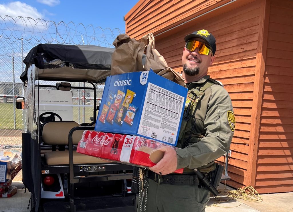 A staff member carries snacks to a distribution area at Mule Creek State Prison.