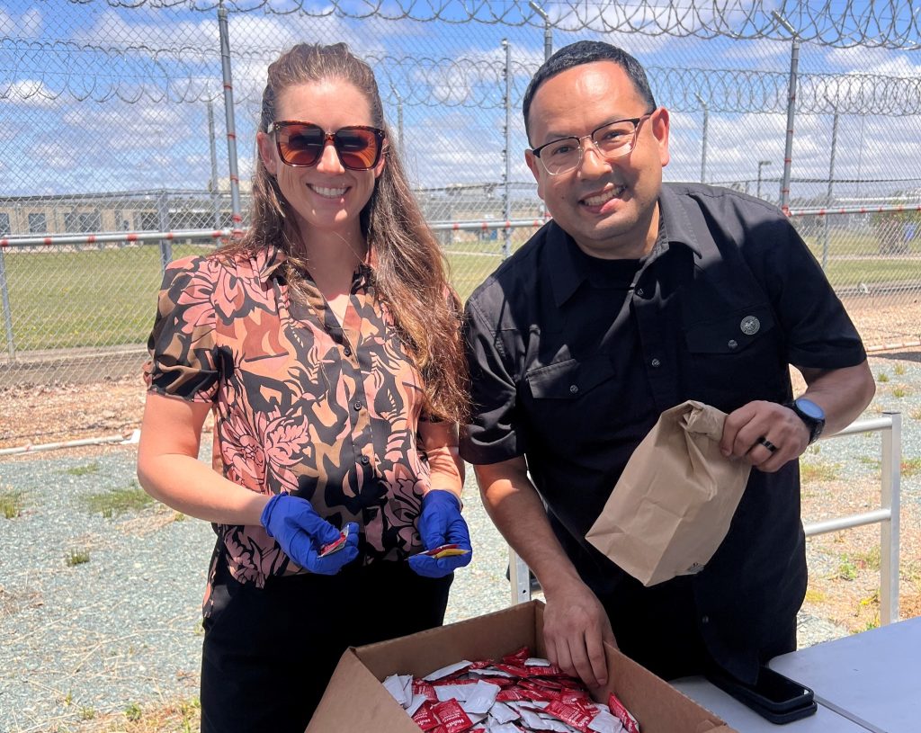 Two people at Mule Creek State Prison for a staff appreciation event.