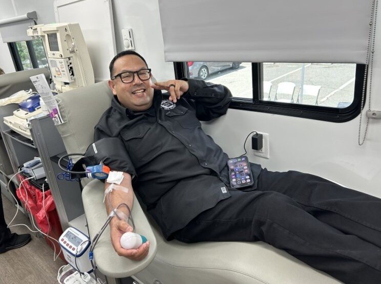 A man in a chair is donating blood at Mule Creek State Prison.