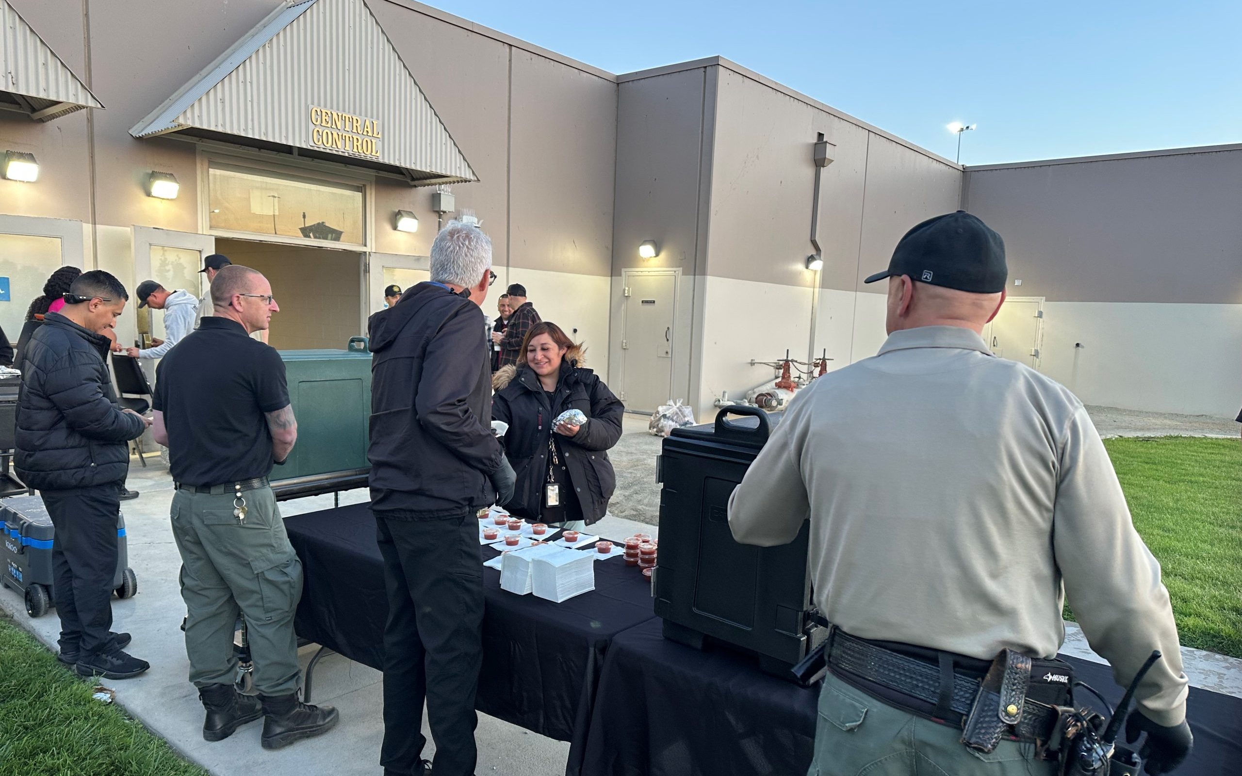 Staff serve breakfast burritos as first watch arrives at North Kern State Prison in Delano.