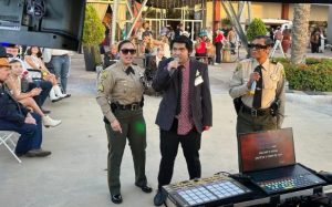 CIW staff volunteers perform karaoke with an attendee of a special-needs prom in Corona.