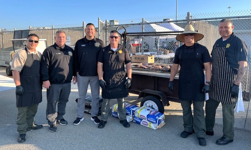 Managers working the grill at SATF staff appreciation.
