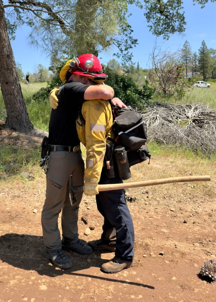 LT. Harkness and son, Cal Fire Captain Harkness, embrace in celebration