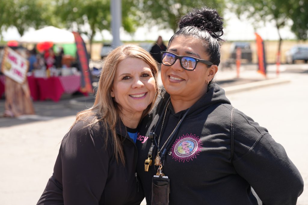 Two staff members smiling during the Valley State Prison event.