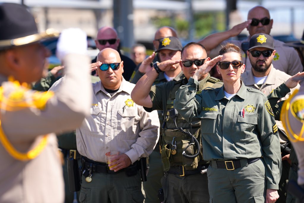 Staff members salute at Valley State Prison. 