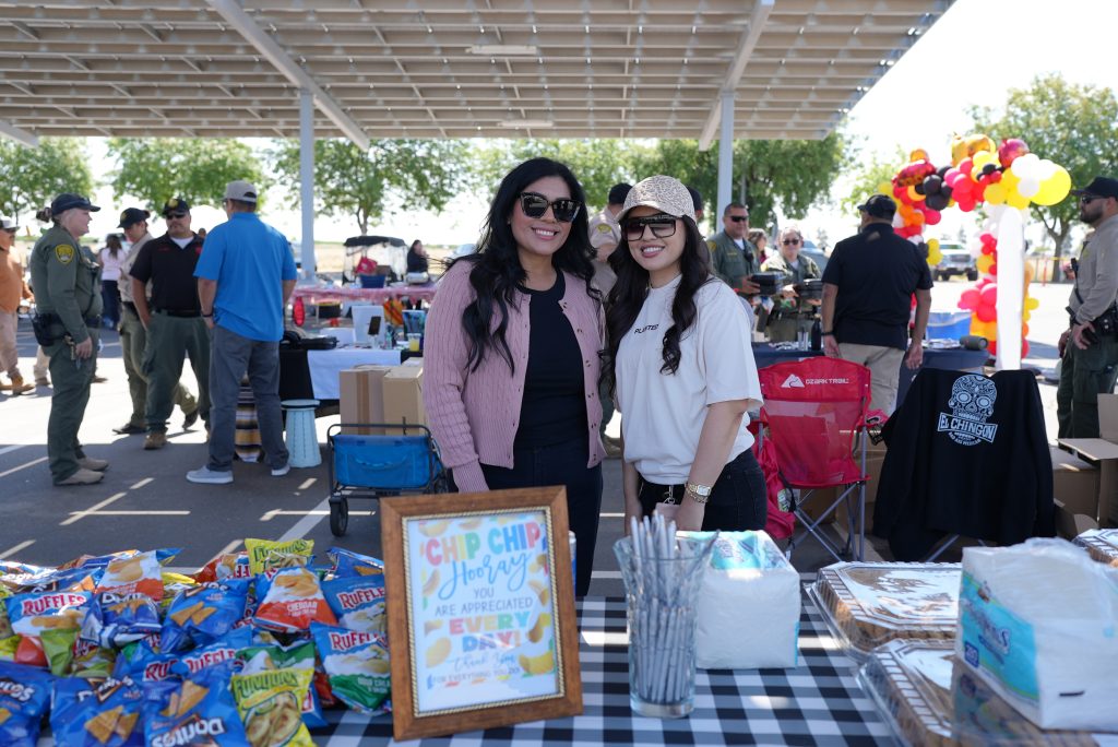 Two staff members at an information table at Valley State Prison. 