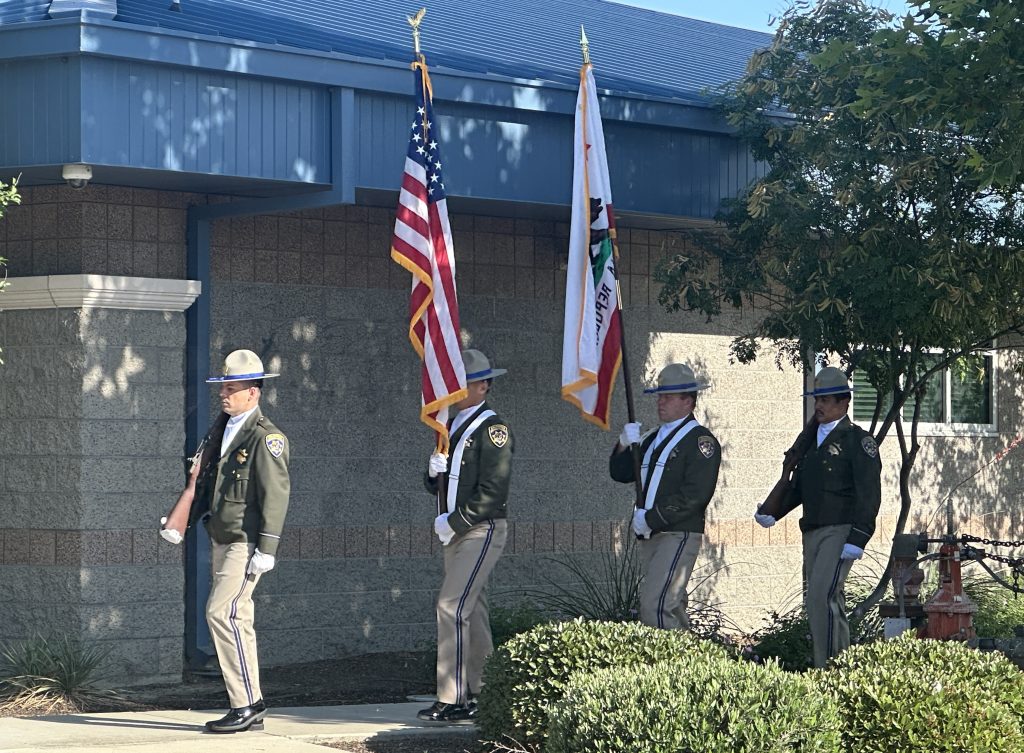 An honor guard presents the colors at the memorial ceremony.