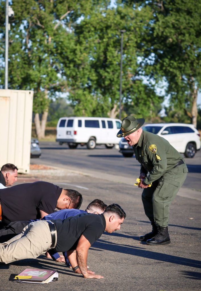 Cadets do push-ups on their first day at the Academy.
