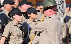 A cadet receives the guidon for her company at the CDCR Academy on June 16, 2026, in Galt, California.