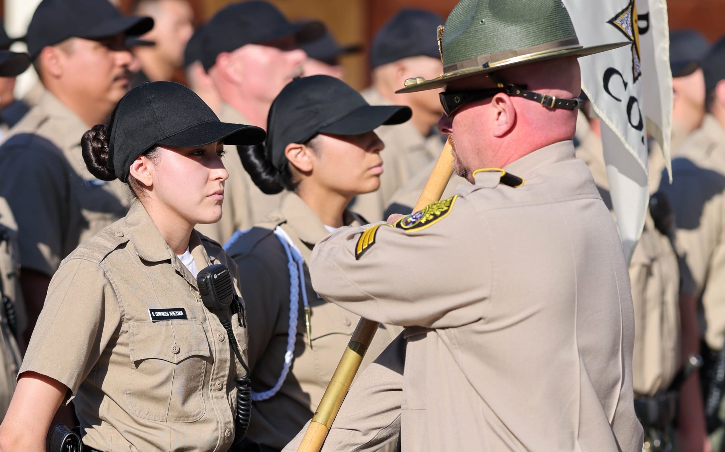 A cadet receives the guidon for her company at the CDCR Academy on June 16, 2026, in Galt, California.