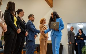 New parole agent shakes hands with executives during the graduation ceremony at the academy in Galt.