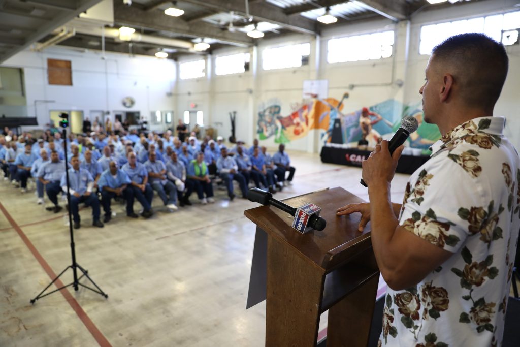 Tommy Deluna speaks to the crowd of graduates at CSP-Solano.
