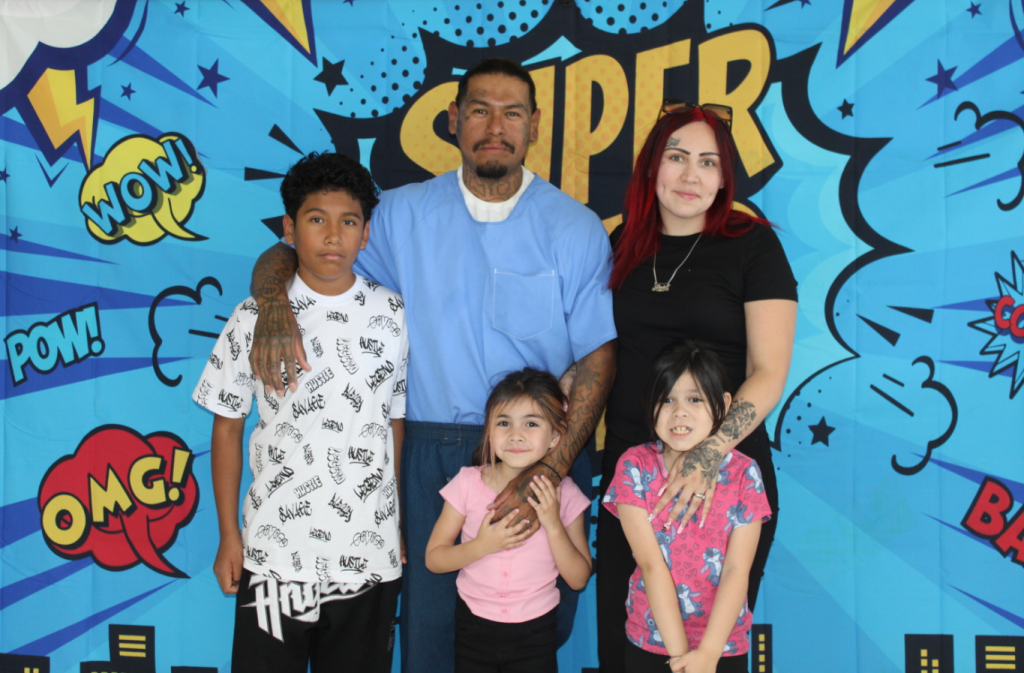 Families posed for photos during Father's Day visiting at Centinela State Prison.