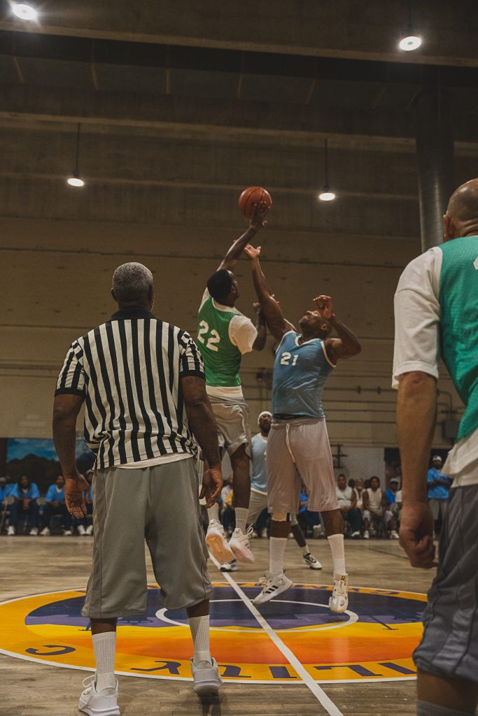 Jumping up for the ball with a referee in the foreground during the CIM tournament.