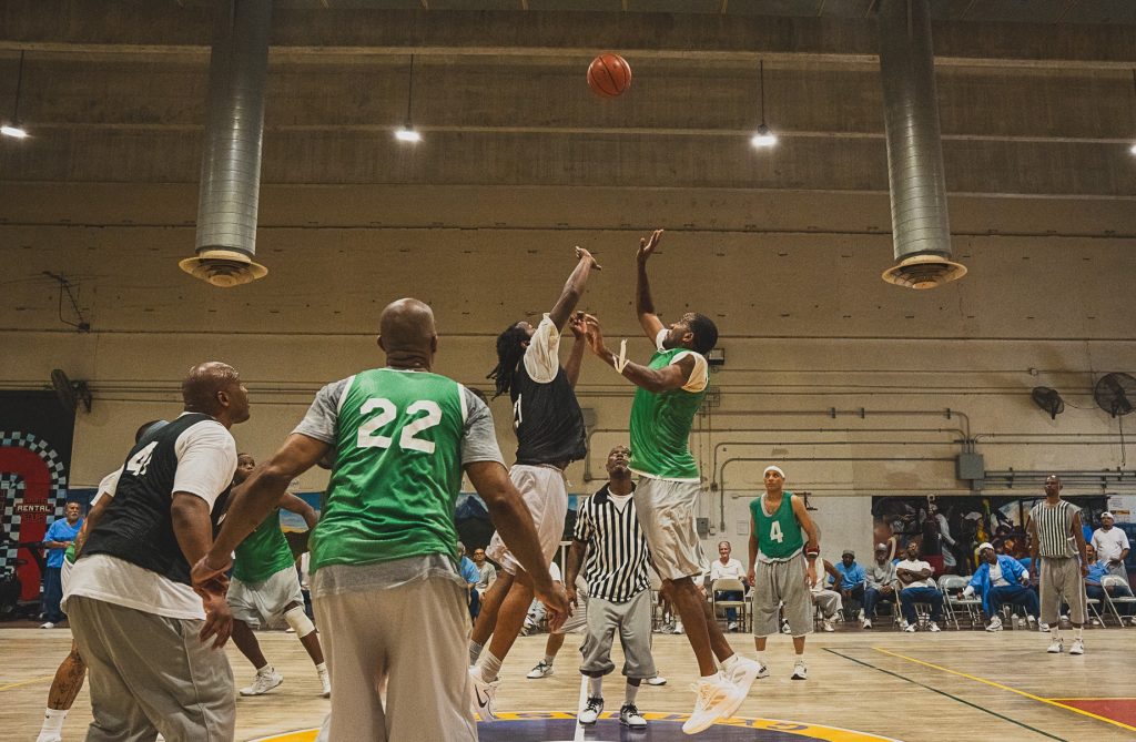 Players leap for the ball during the basketball game.