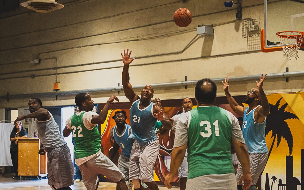 An incarcerated basketball player throws the ball during a tournament at California Institution for Men, or CIM, in Chino