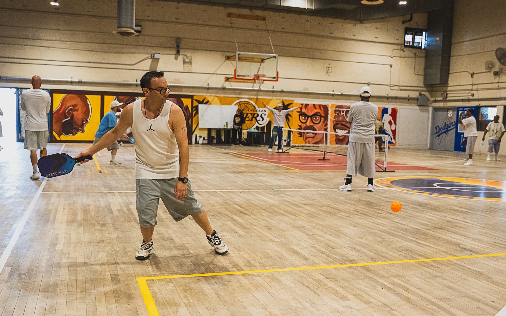 Wide angle of gymnasium at CIM for the pickleball tournament.