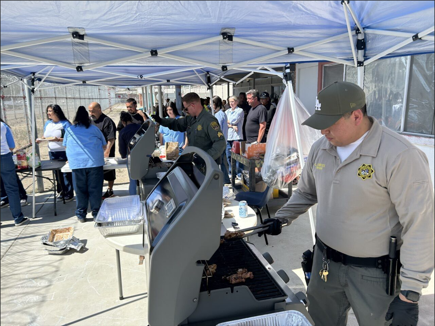 Staff work a grill for Father's Day visiting at California Institution for Women.