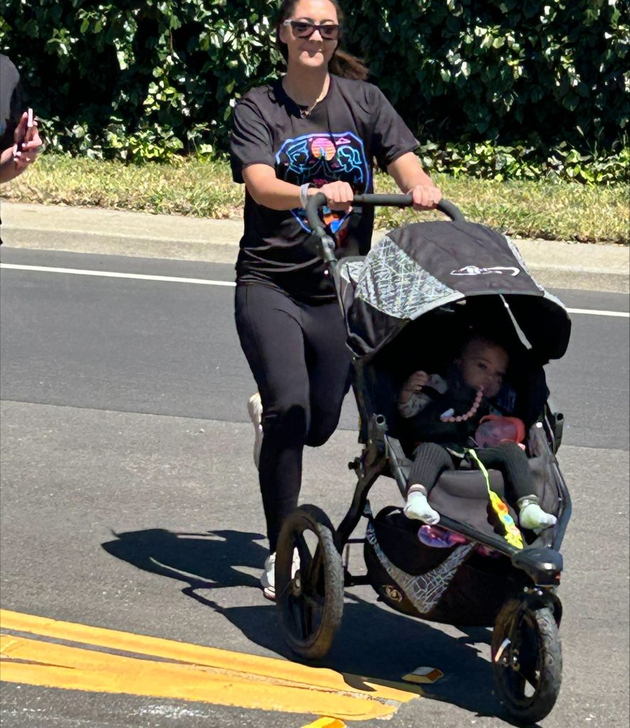 Woman runs with stroller for CMF 2026 Torch Run.
