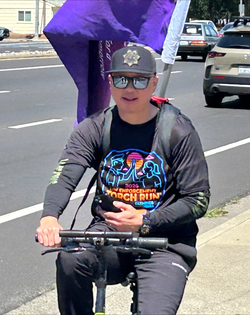 Man on scooter for CMF 2026 Torch Run.
