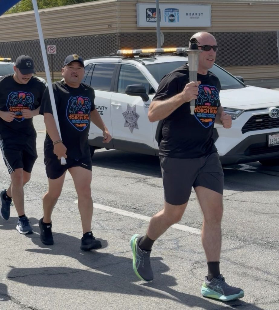Man carries torch during CTF and SVSP run.