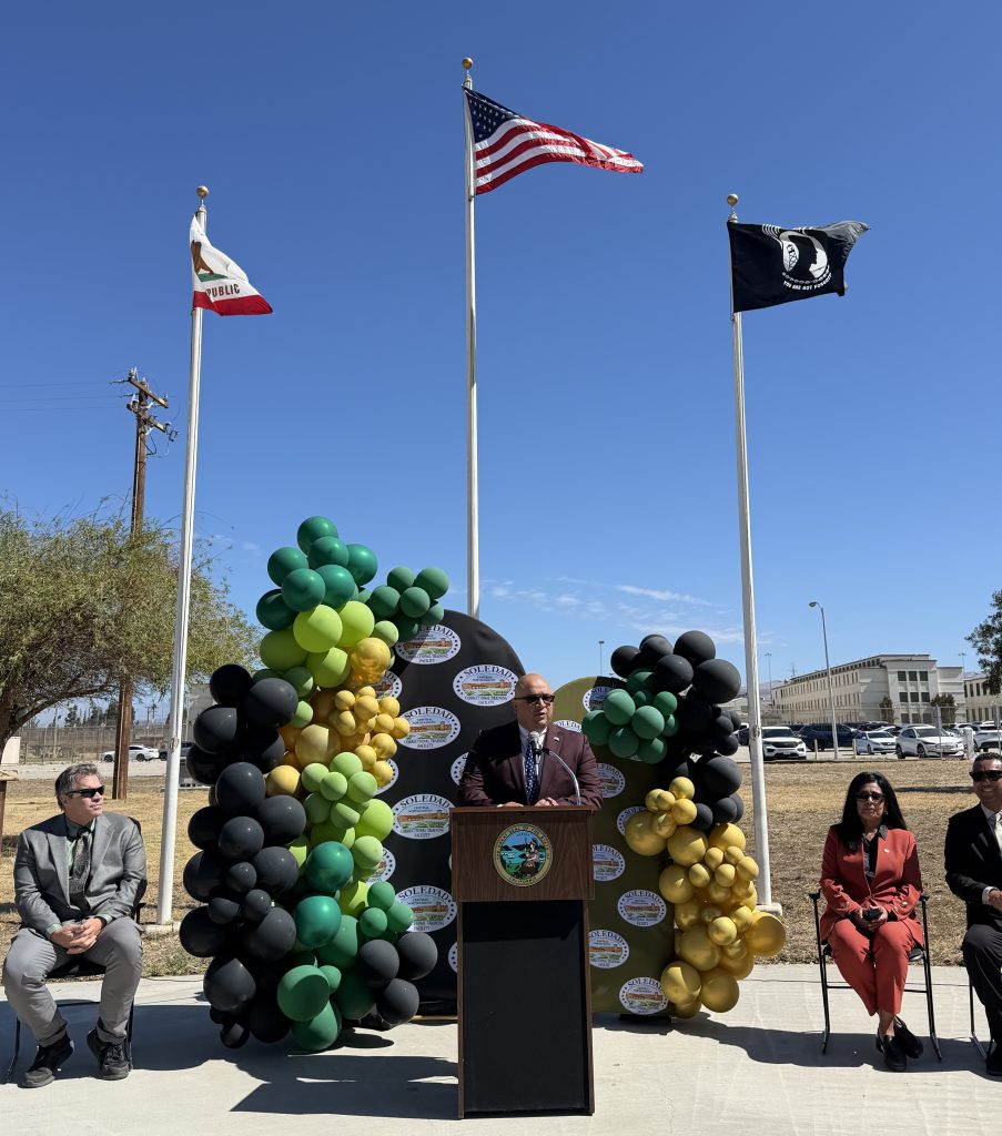 Chief Deputy Warden speaks at lectern at CTF's staff promotional ceremony.