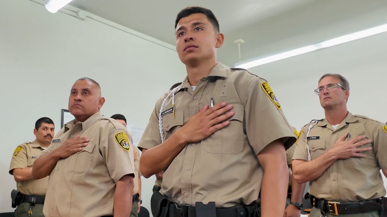 Barajas and other cadets from class 2-26A with their hands over their hearts.