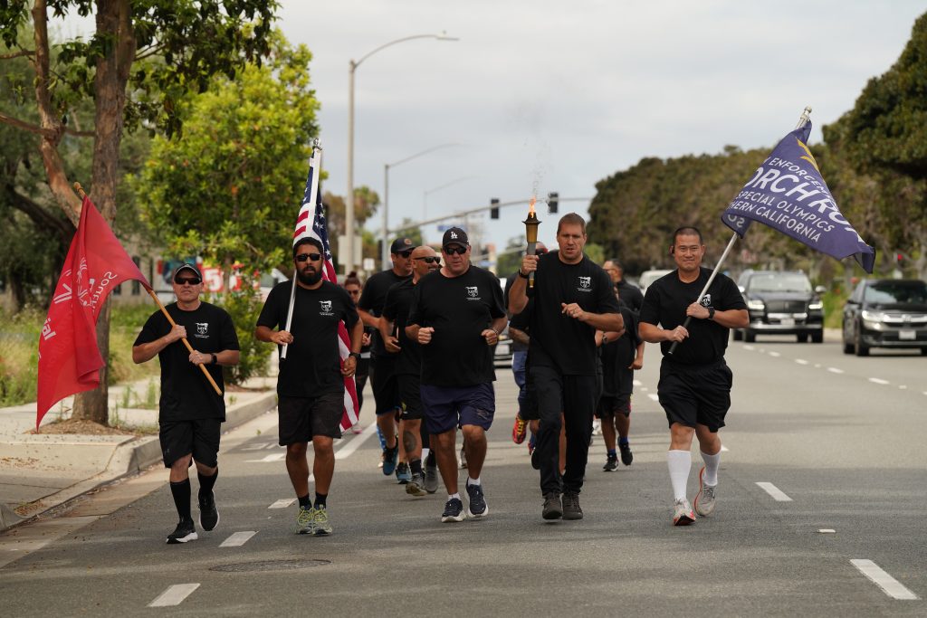 Group photo of parole staff in the southern region carring the torch for Special Olympics.