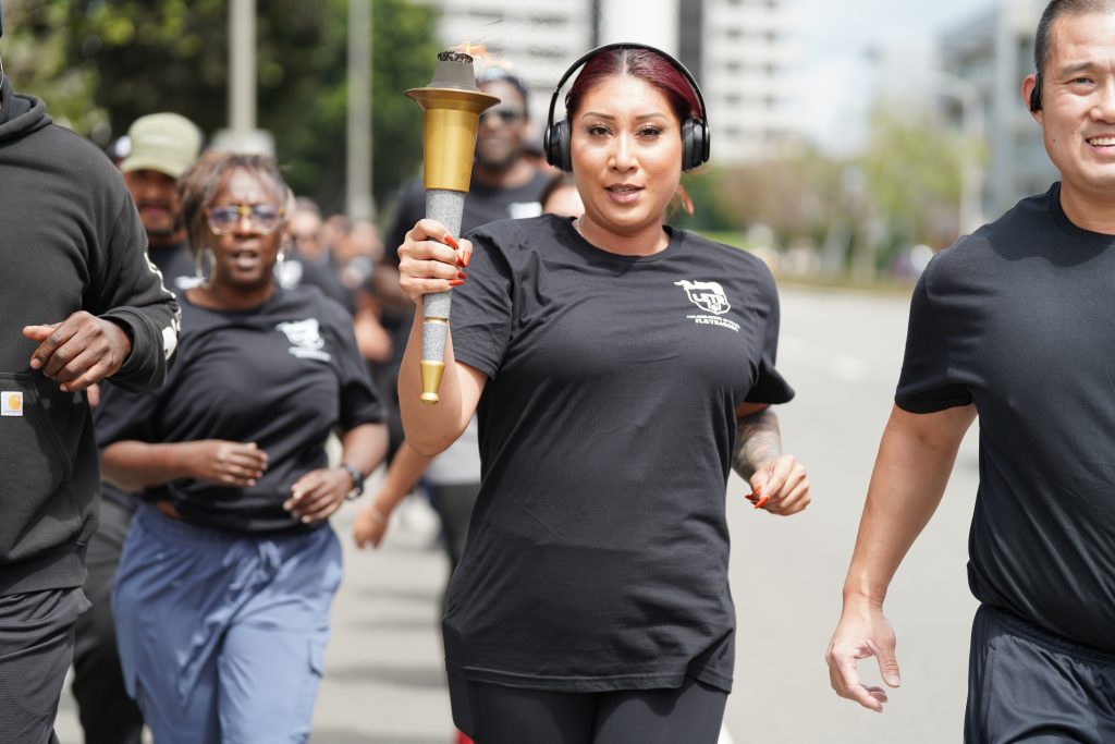 Woman smiles while carrying the torch in Southern California.