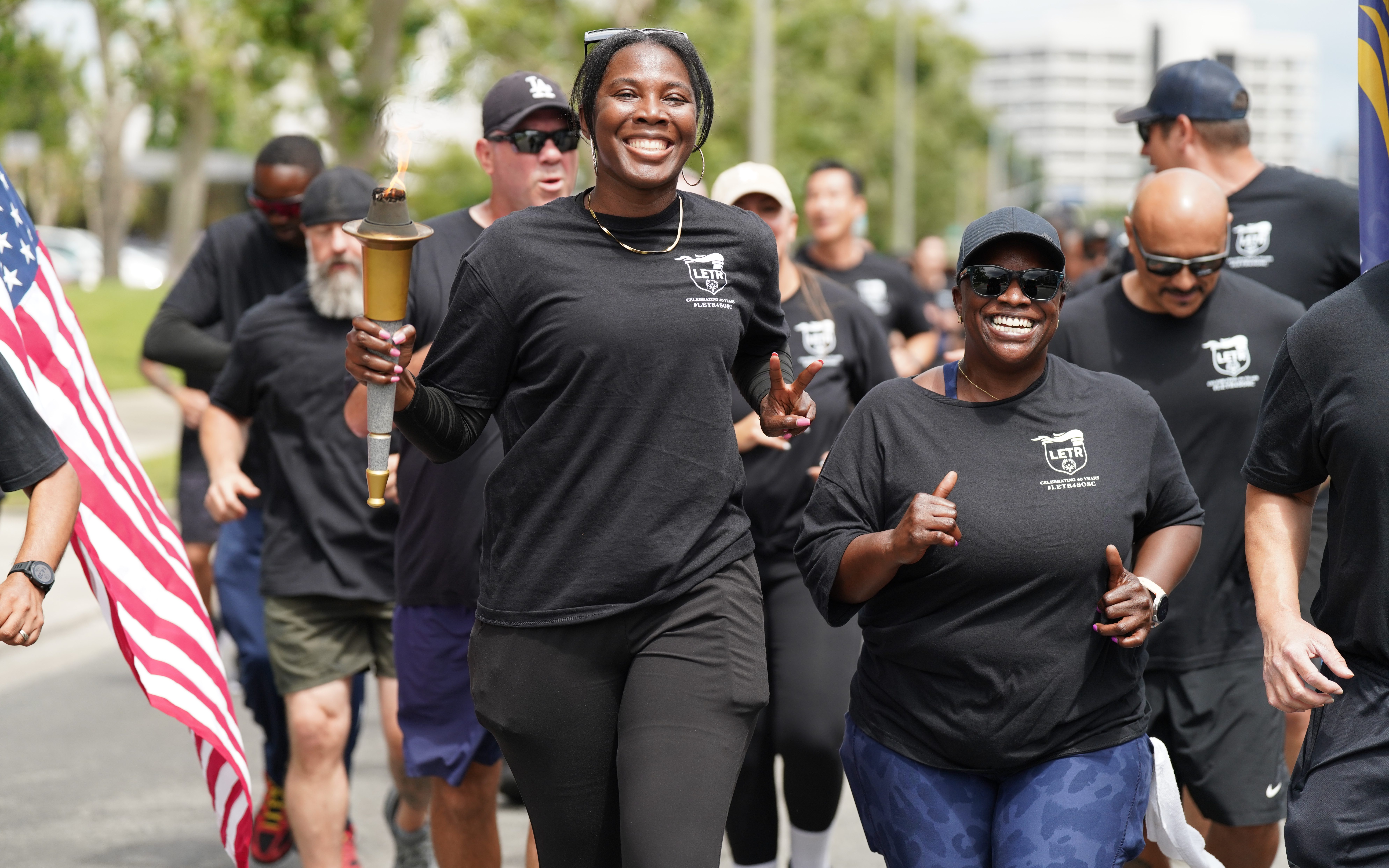 Woman smiling while carrying the torch.