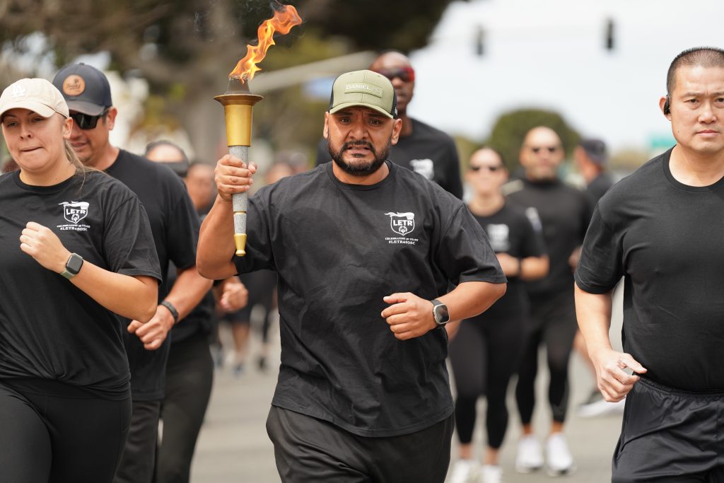 A man carries the torch for Special Olympics in the southern region of California.