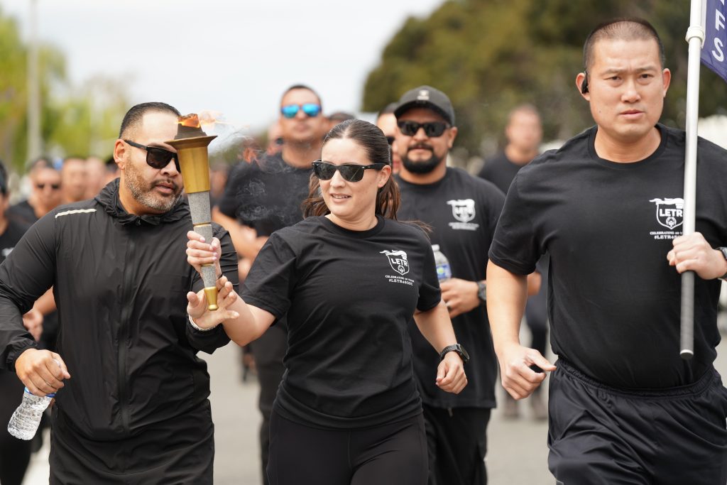 Division of Adult Parole Operations staff in the southern region carry the torch for Special Olympics.
