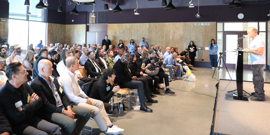 Dave Dahl, founder of Dave's Killer Bread, speaks to those attending the showcase at San Quentin.