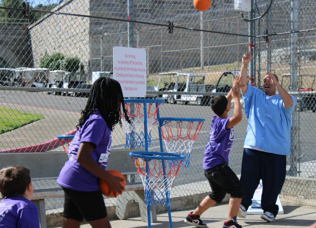 Playing a basketball style game during Get on the Bus at Folsom State Prison.