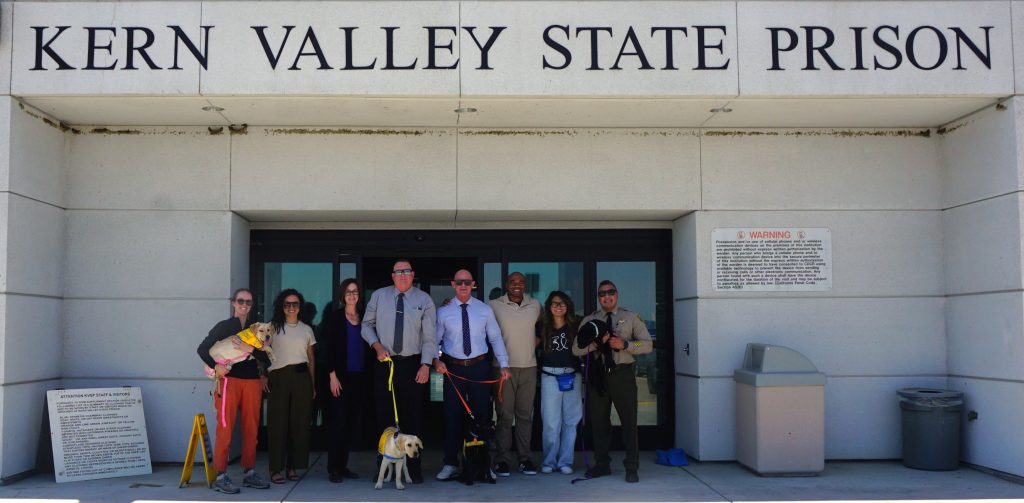Canine Companion with staff at Kern Valley State Prison.