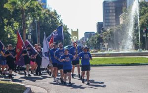 Special Olympics athlete and CDCR/CCHCS runners carry flags during the Capitol leg of the 2026 Law Enforcement Torch Run.