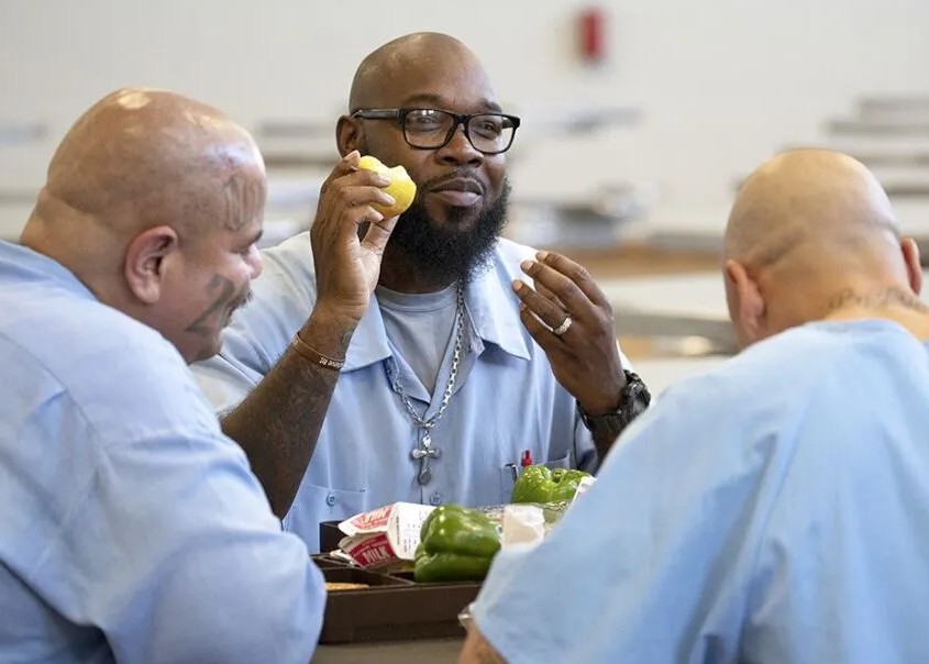 Incarcerated individuals eating produce