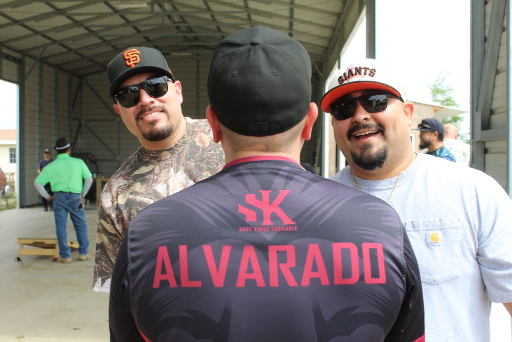 Staff goof around for the camera at a cornhole tournament held off-site from Pleasant Valley State Prison in Coalinga.