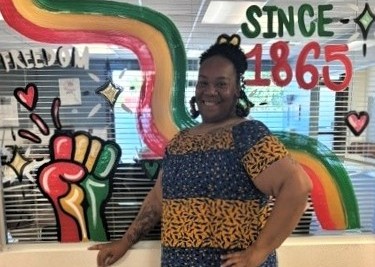 Mayaika Ellis posed in front of Juneteenth display