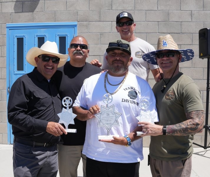 Staff members hold trophies at the RJD staff appreciation event.
