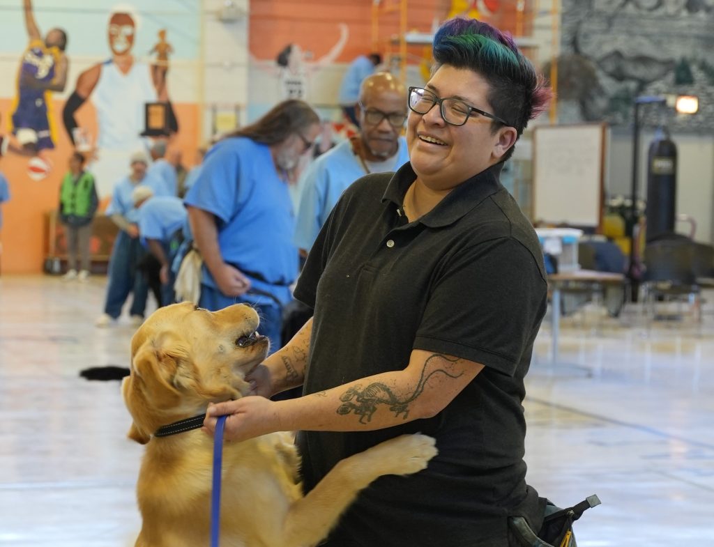 Hayley and a canine with Paws on a Mission at CSP-Solano.