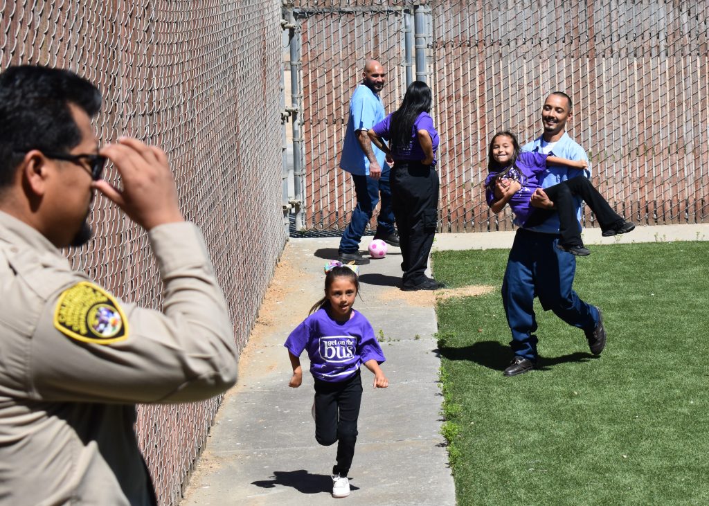 Families play in the outdoor area of SVSP visiting.