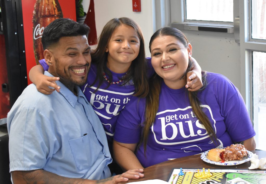A family smiles during visiting at Salinas Valley State Prison.