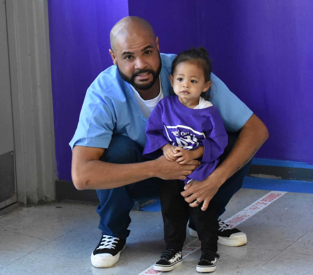 Salinas Valley State Prison with a toddler and their incarcerated loved on during Get on the Bus.