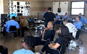 Group of people at From Bars to Beats music rehabilitation event at Valley State Prison in Chowchilla.