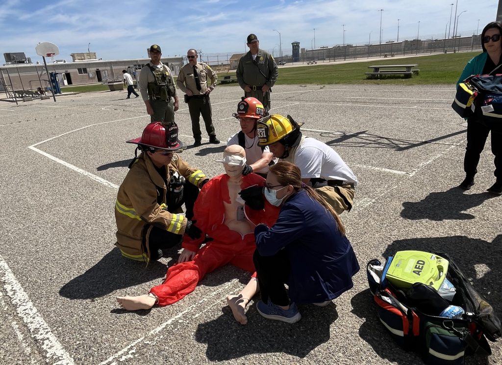 Custody staff observe the medical emergency drill at the Wasco prison and reception center.