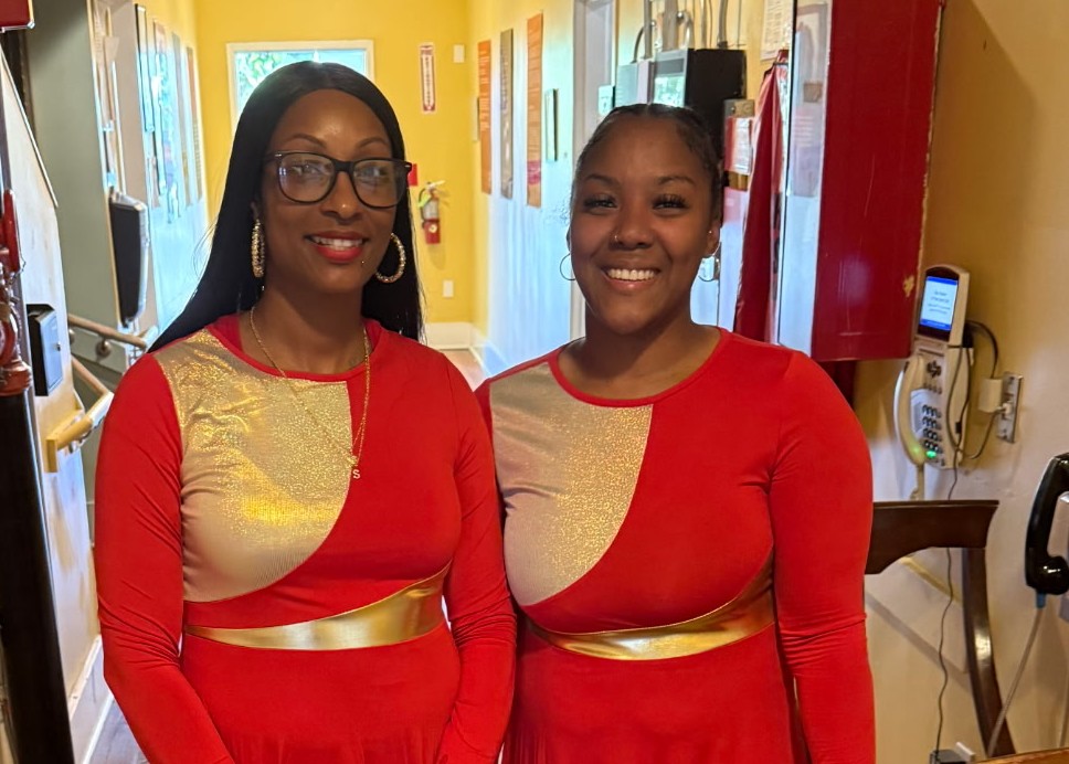 Praise Dance performers Shagirah Joyce and Raynise Bass in colorful dresses at Juneteenth event