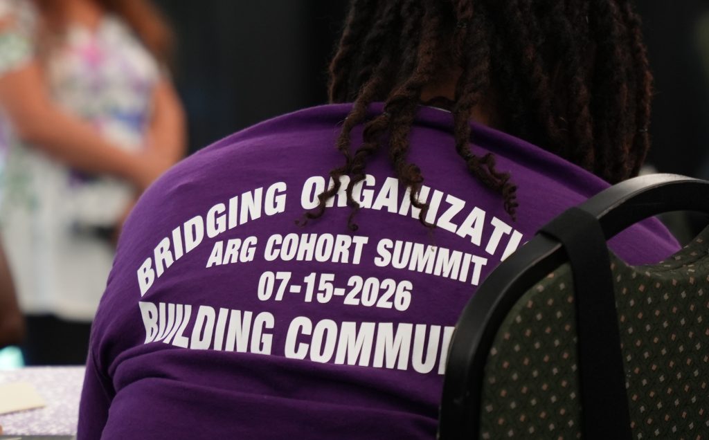 A t-shirt with the words: Bridging organizations, ARG Cohort Summit, 7-15-2026, Building Community.