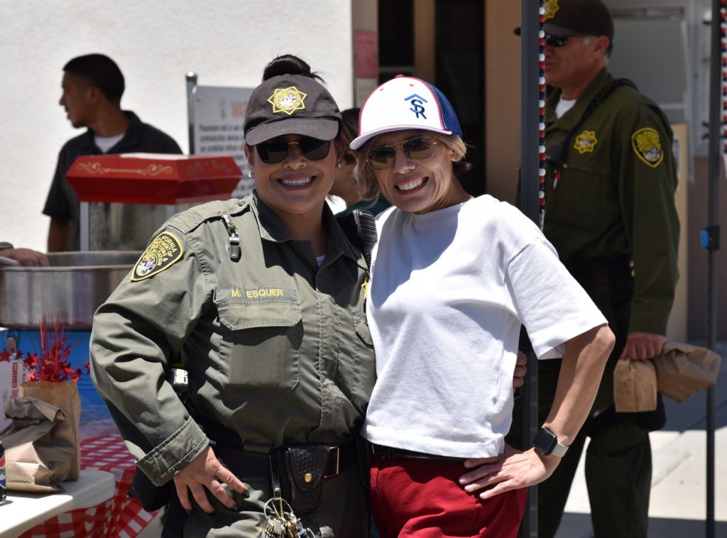 Two women smiling at the event at Avenal State Prison.