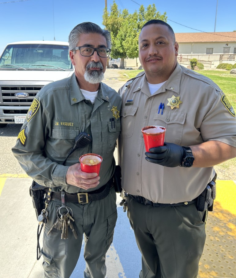 Two custody staff members hold beverages at Avenal State Prison.